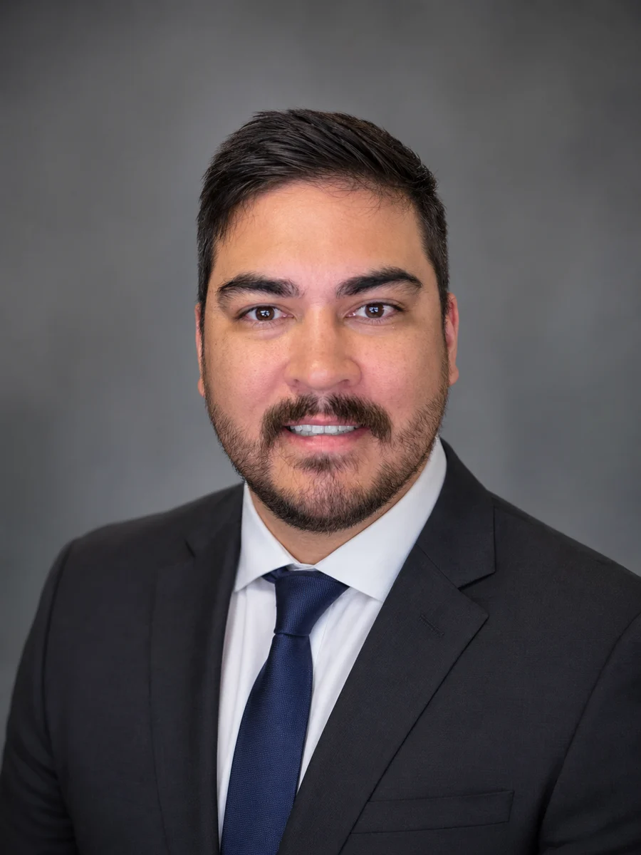 Jeremiah W. Jones in a dark suit and blue tie